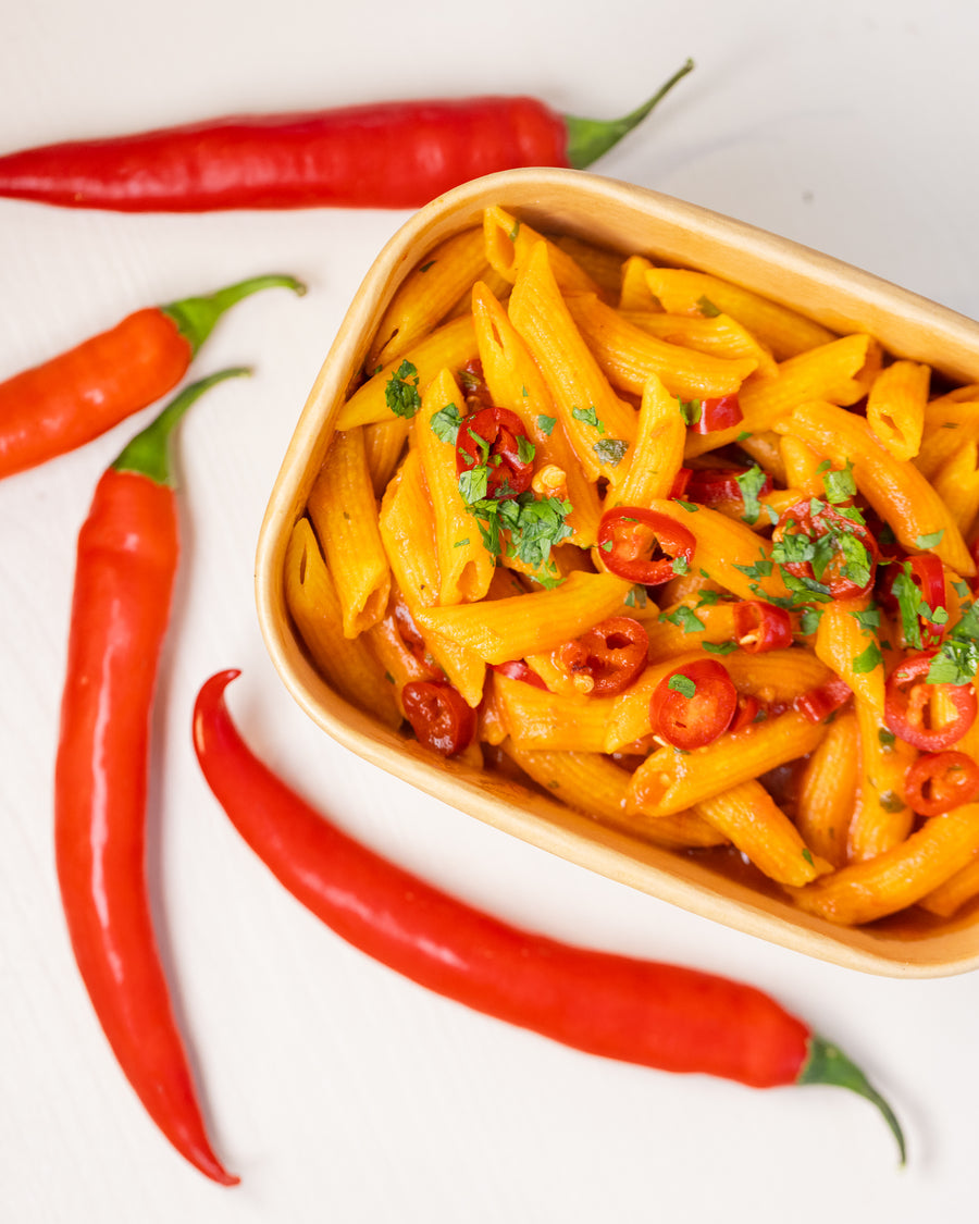 Penne arrabbiata in a Bigoli takeaway box with fresh red chillies