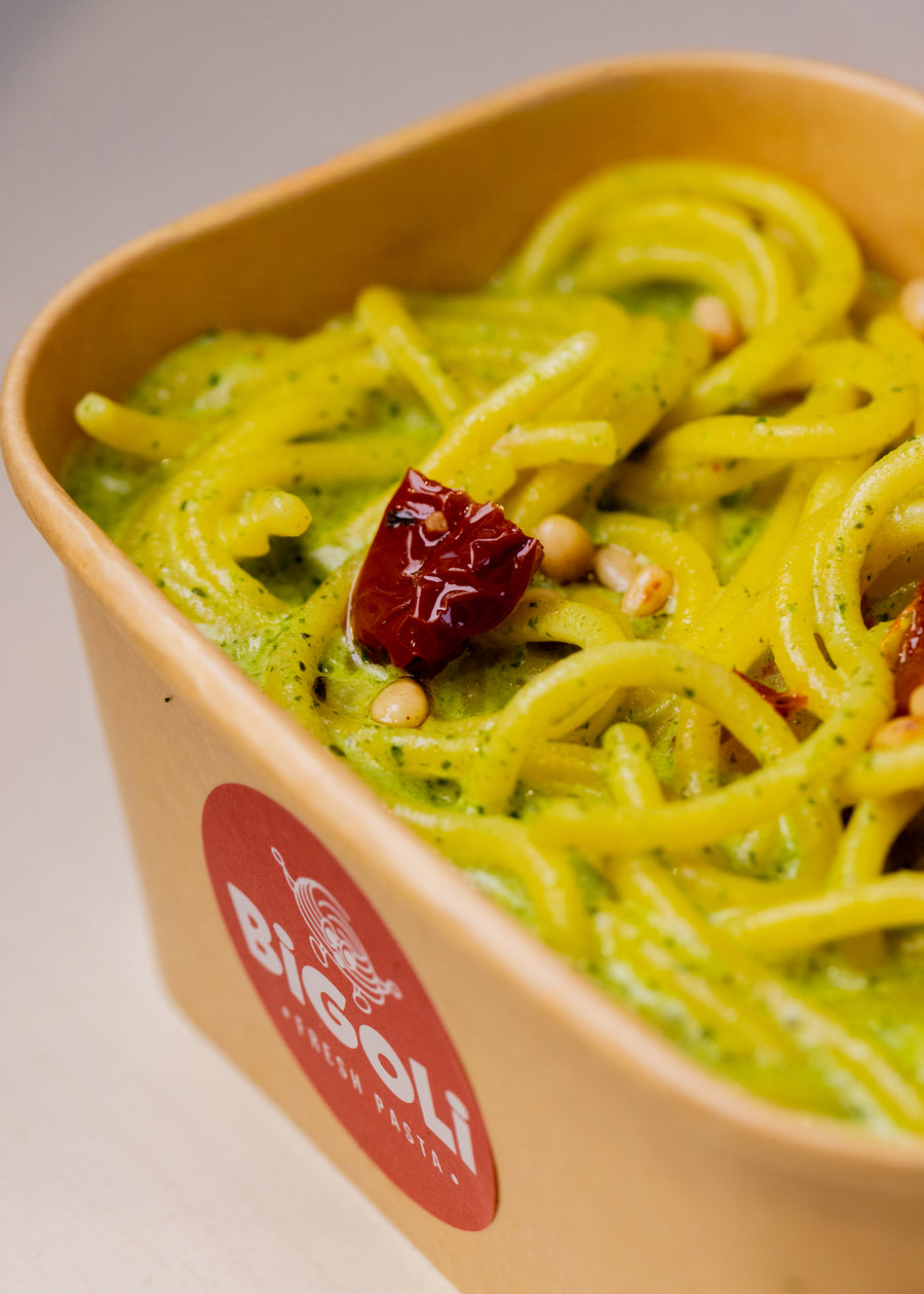 Pesto with pine nuts and sun-dried tomato on fresh pasta in a Bigoli takeaway box, Old Street