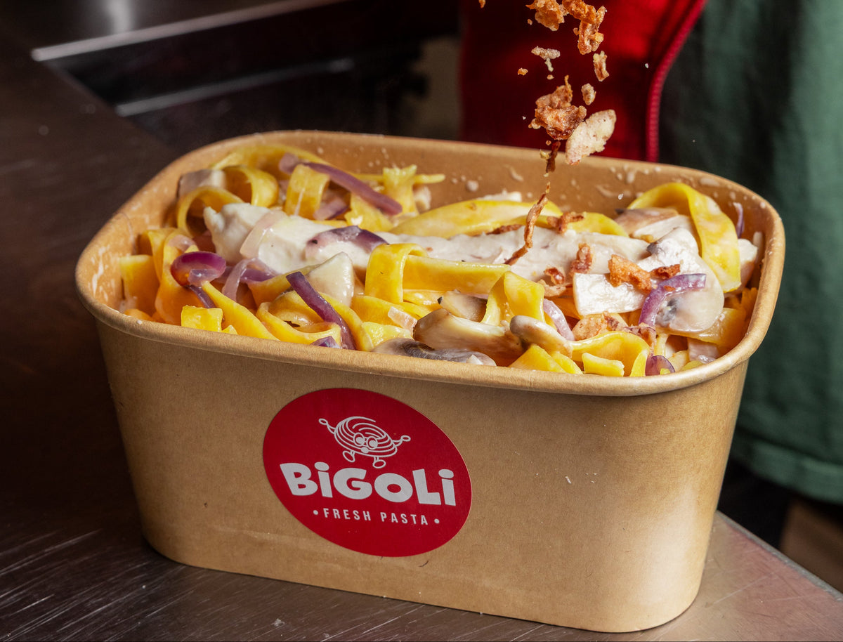 Fettuccine in a creamy mushroom and red onion sauce in a Bigoli takeaway box