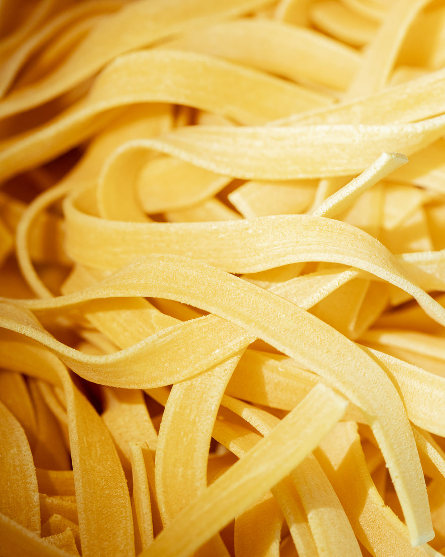 Freshly cut fettuccine ribbons at Bigoli