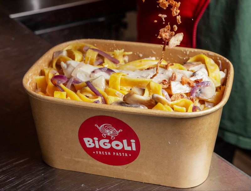 Fettuccine in a creamy mushroom and red onion sauce, in a Bigoli takeaway box
